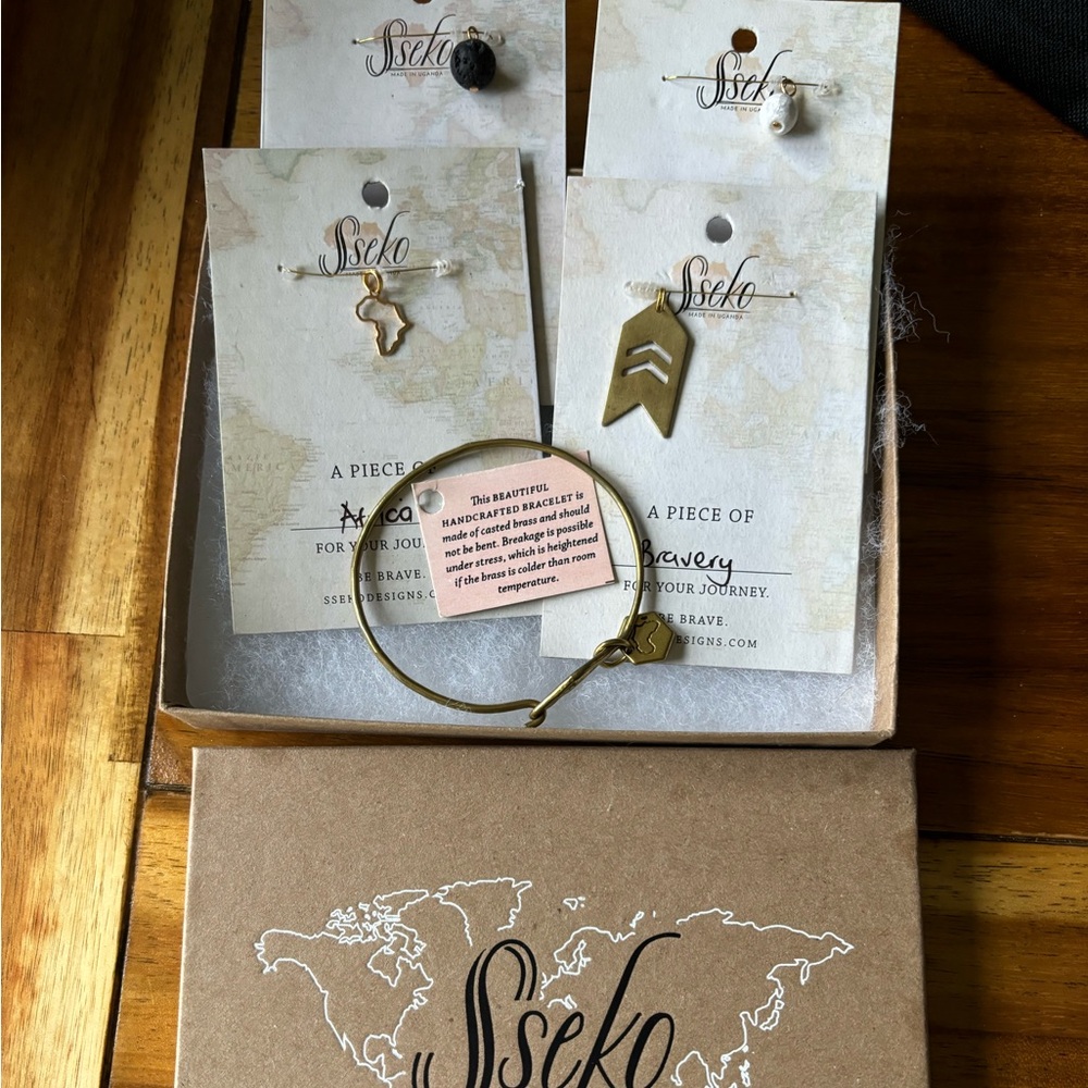 NIB Sseko brass bracelet with 4 charms. Never been worn!